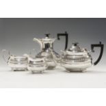 An Edward VII four piece silver tea service with gadroon and scallop border, fluted frieze,