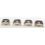 A set of four Victorian plain silver salts, beaded rim on three stylised shell and hoof feet,