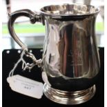 A George III plain silver baluster shaped mug, C-scroll handle, spreading circular foot,