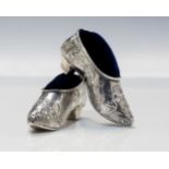 A pair of Victorian 930 standard silver shoe shaped novelty pin cushions,