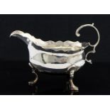 A George III silver sauce boat, ogee border and C scroll handle, on three trefoil feet,