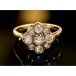 An 18ct gold and diamond off-set square cluster ring,