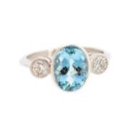 An aquamarine and diamond platinum three-stone ring, the central oval-cut aquamarine approx 2.