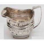 A George III silver helmet shaped cream jug, London 1811, with gadrooned border,