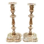 A pair of George V silver candlesticks of Georgian design, detachable bobeches, knopped stems,