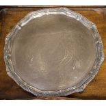 An Edward VIII silver salver with a Celtic style border, raised on three feet,