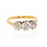 A three-stone diamond 18ct yellow gold ring, the old-cut diamonds approx 1.