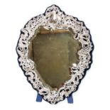 A large Edwardian silver mounted cartouche shaped easel looking glass,