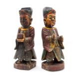 A pair of mid 19th Century Chinese reliquary treen figures, carved as robed gents, one bearing a