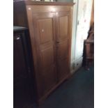 An Arts and Crafts style hand crafted two door wardrobe, of recent manufacture, joined construction,