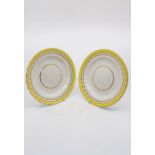 Two Derby fluted edge plates with a yellow band and gilt borders, Exhibition Label on reverse, circa
