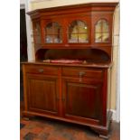 An Edwardian mahogany bookcase, with an upper glazed section, the base with two drawers over two