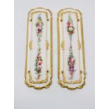 A pair of Copeland and Garrett door panels, each painted with floral garlands within a relief