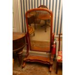 A Victorian mahogany cheval mirror on 'S' scroll and dual supports united by a platform