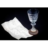 A George III Continental glass, etched with the Royal cypher on a turned wooden base; accompanying