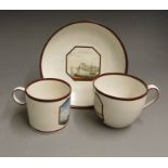 A Derby trio, tea & coffee cups and saucer, painted with seascapes by George Robertson and painted