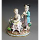 A Meissen figure group of a boy and girl representing Autumn, with a goat harvesting on grapes,
