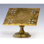 A  late 19th Century ecclesiastical Gothic brass table top lecturn attributed to John Hardman