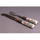 A Meissen knife and fork with porcelain handles set in white metal mounts, the handles are painted