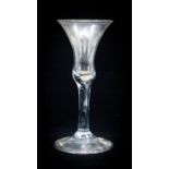 An 18th century wine glass, the bell shaped bowl on tear included stem, on folded conical foot, 17.