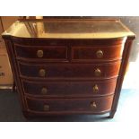 A George IV mahogany inlaid bow fronted chest of drawers, fitted with two short over three long