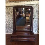 A George III mahogany toilet mirror, fitted with three drawers