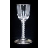 An 18th century wine glass, circa 1750, the round funnel bowl supported on a douple strand opaque