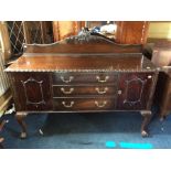 An early 20th Century Chippendale style mahogany sideboard, three drawers and two doors, cabriole
