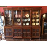 A late Victorian Collinson and Locke walnut breakfront library bookcase, circa 1895, made in