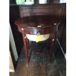 An early 19th Century mahogany lady's work table, circa 1810, the lid opening to reveal a fitted