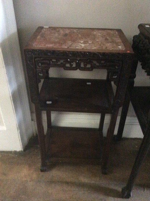A 19th Century Chinese three-tier occasional table, the top with inset red marble, carved frame,