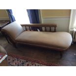 A Victorian walnut chaise longue, upholstered in cream fabric, with a turned gallery back, raised on