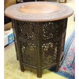 An Indian 19th Century 'Campaign' table with intricate carving, with brass inlay.