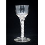 An 18th century opaque twist wine glass, the ogee bowl on double strand and lattice corkscrew core