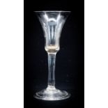 An 18th century wine glass, the bell shaped bowl on plain stem and folded conical foot, 17.8cm high,