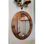 An iconic Liberty and Co brass and copper-framed mirror with 4 Ruskin turquoise ceramic cabochons.
