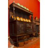 An early 20th Century oak sideboard, having a carved front, the upper section with barley twist