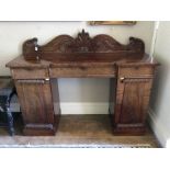 A Victorian twin pedestal sideboard