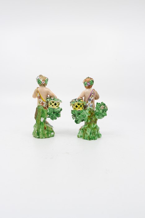 A pair of Derby cherubs, standing before bocage holding a basket, circa 1790, height 12cm (2) - Image 3 of 4