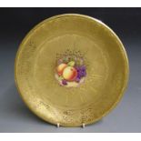 A Royal Worcester acid etched gilded cabinet plate with a central reserve painted with fruit