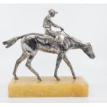 A silvered metal desk model of a jockey on a trotting horse, circa 1930's, height 19cm ,mounted on