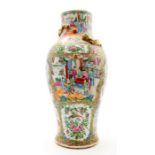 A mid 19th Century Cantonese enamel vase, decorated in the famille rose palette with panels of