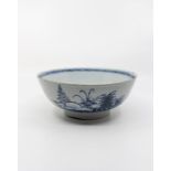 An English Delft bowl, with oriental influenced naturalistic scenes, on stepped pedestal foot rim,