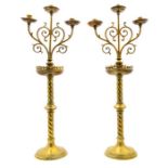 A pair of late 19th Century brass ecclesiastic triple light candelabra, attributed to John Hardman