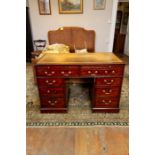 A George III mahogany twin pedestal desk, gilt tooled inset leather writing surface, two slides