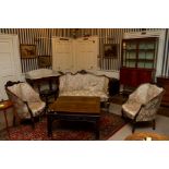 A mahogany Edwardian suite consisting of a sofa and 2 chairs. Upholstered in green and pale floral