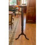A mahogany torchere, with carved spiral column. H140cm approx