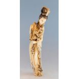 A large Chinese Guanyin ivory, late 19th/early 20th Century, carved standing holding a floral