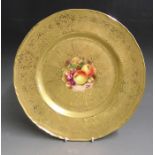 A Royal Worcester large acid etched gilded cabinet plate with a central reserve painted with fruit