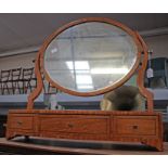 A George III satinwood toilet mirror, the adjustable mirror supported over a bow-fronted base